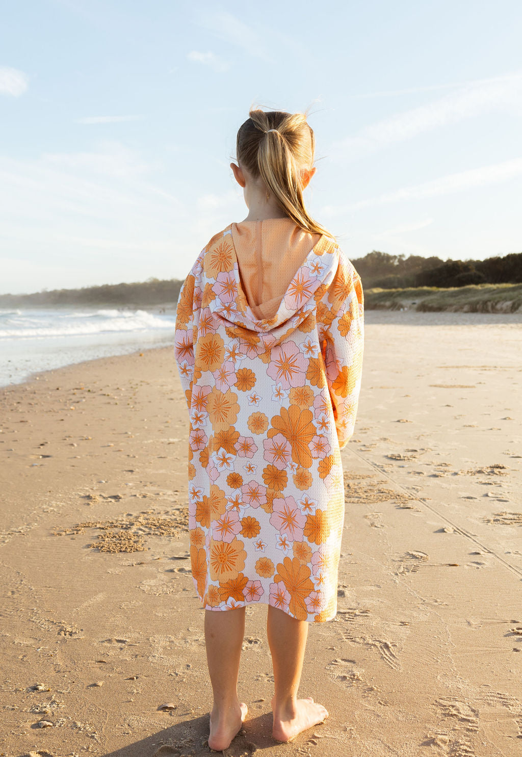 Child in floral hooded towel – microfibre, zipped, sun-safe