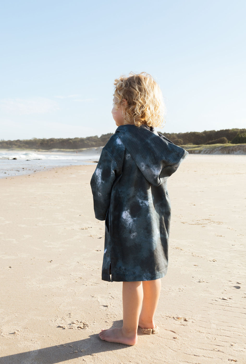 Child in microfibre beach towel with storm theme