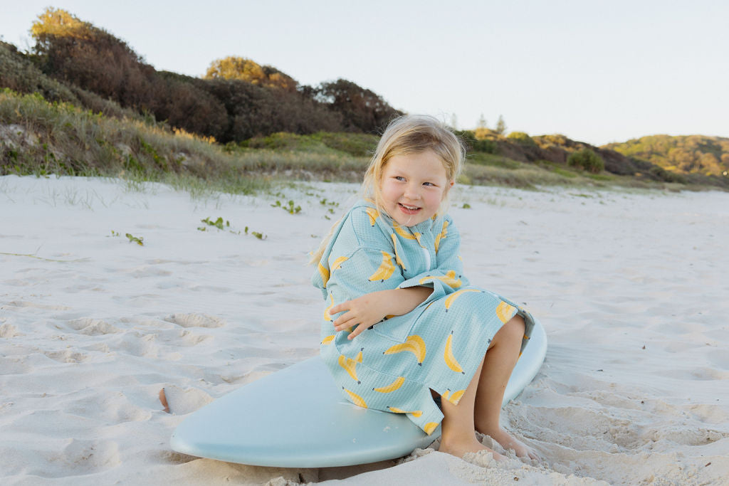 Wearable kids towel on child in banana party design